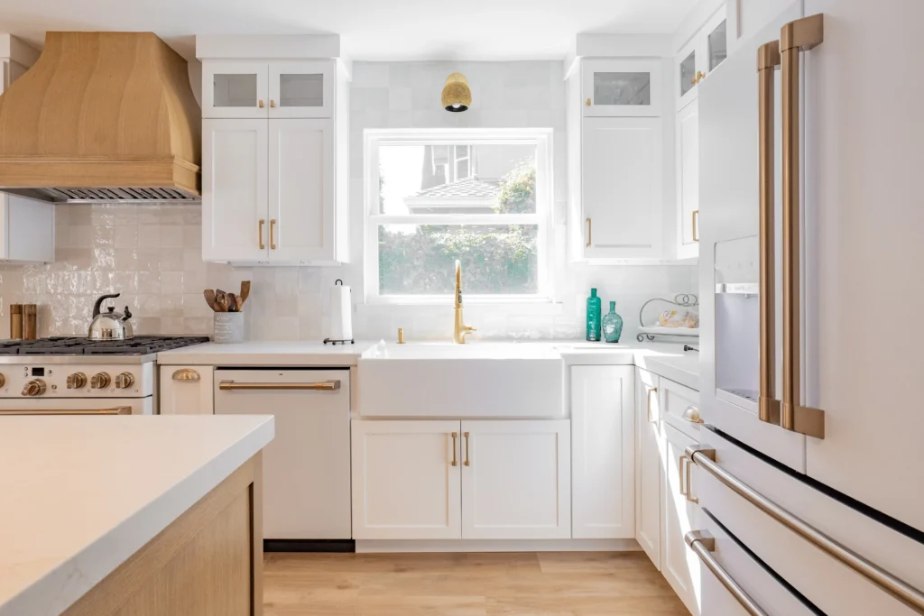 Kitchen interior painting with bright white walls and cabinets in a residential home